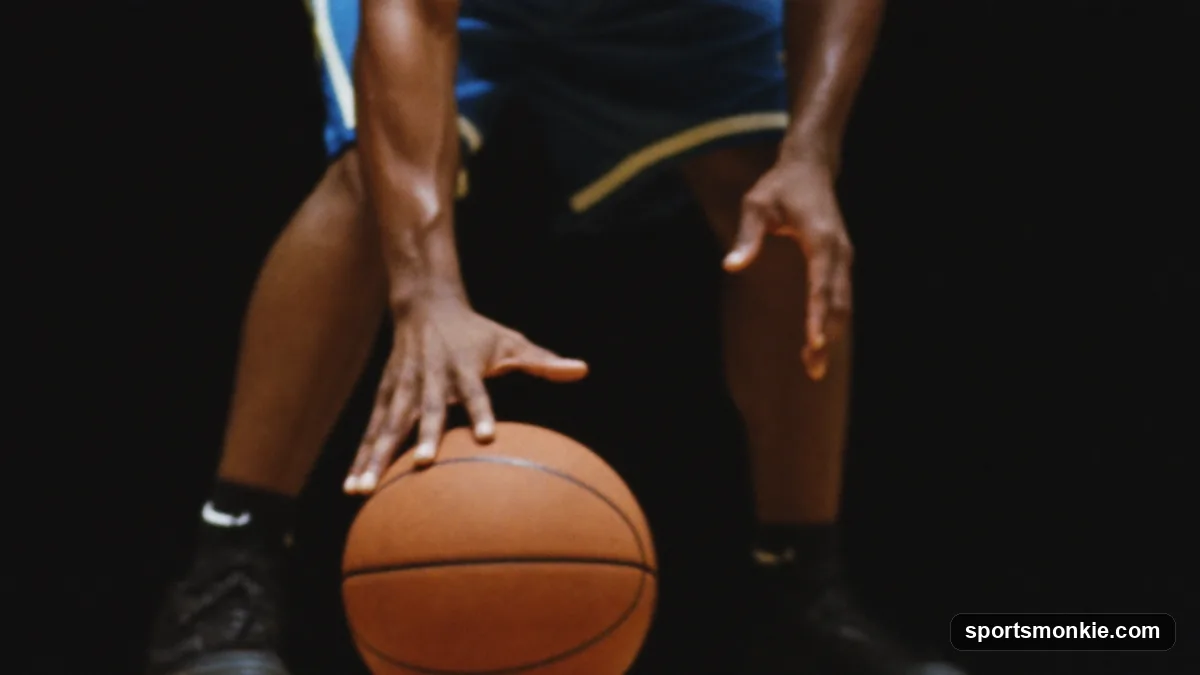 Guard driving a low crossover dribble below the knees to change direction past a defender