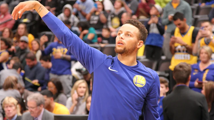 File photo from 4 November 2017: Stephen Curry warms up in a Warriors top before a game in Denver. It does not show Sunday's open practice at Chase Center. The 16:9 cropped derivative is offered under the same CC BY-SA 4.0 licence.
