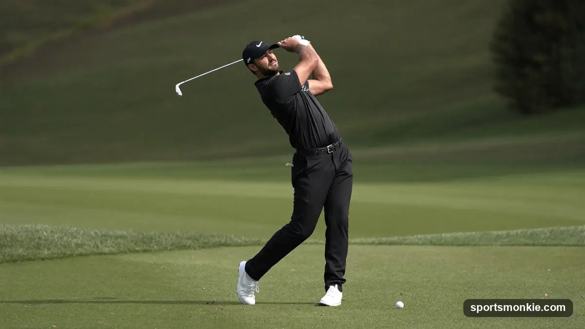 Golfer mid-downswing on the range, hips driving toward the ball during an iron shot