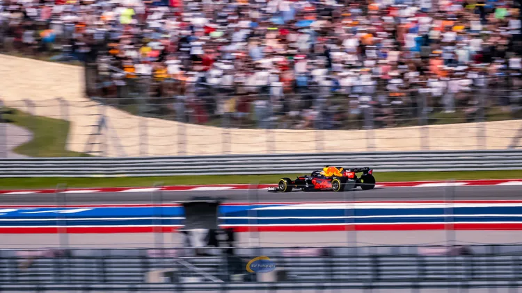 File photo from October 24, 2021: a Red Bull Formula 1 car on track at the Circuit of the Americas during the United States Grand Prix, in front of a packed grandstand. It does not show a 2026 car or the fuel flow meter at the centre of the lawsuit.