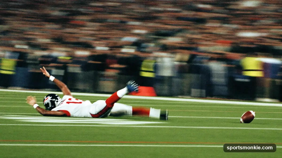 A football player sprinting out of a three-point stance on turf