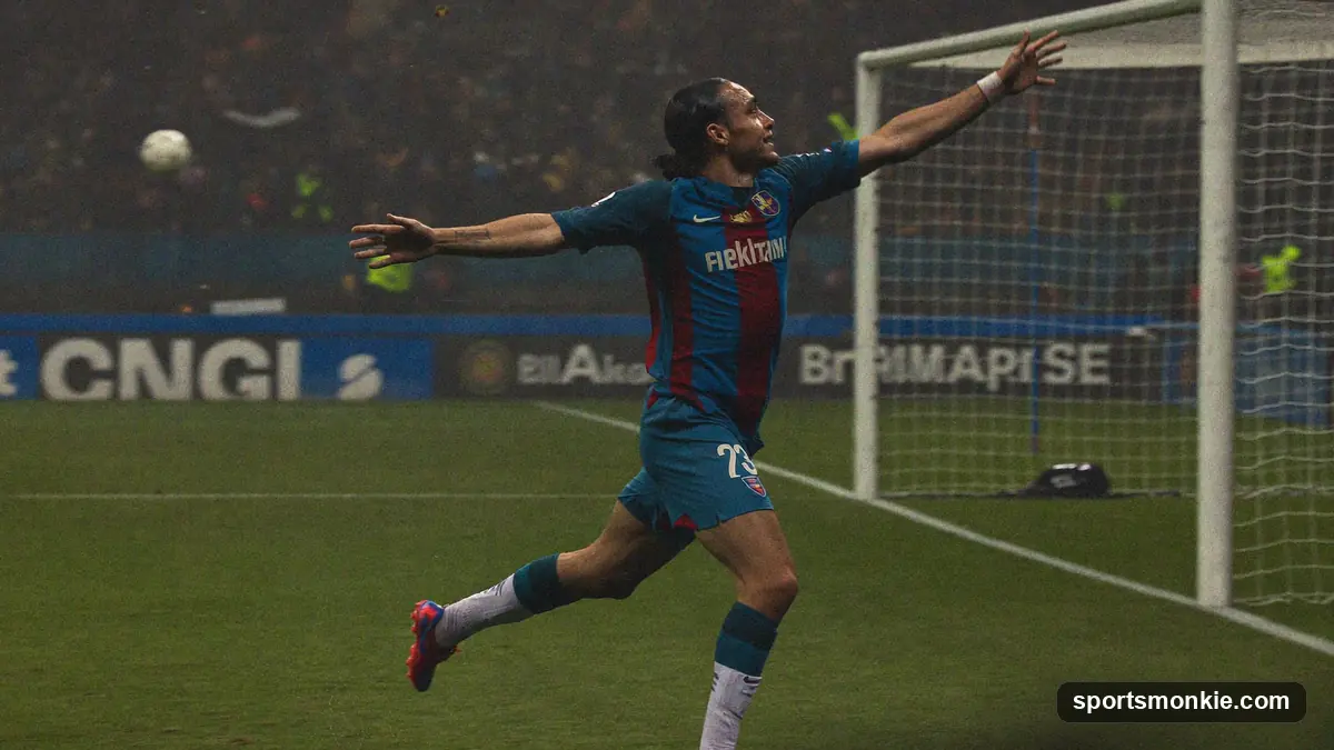 Football player celebrating a goal in front of a packed stadium