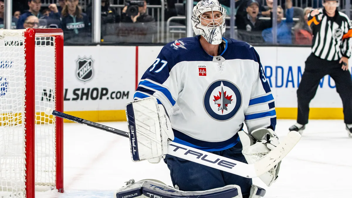 File photo from October 24, 2024: Winnipeg Jets goaltender Connor Hellebuyck in his crease during a game against the Seattle Kraken. It predates the holdout by two years. The 16:9 cropped derivative is offered under the same CC BY-SA 2.0 licence as the original.