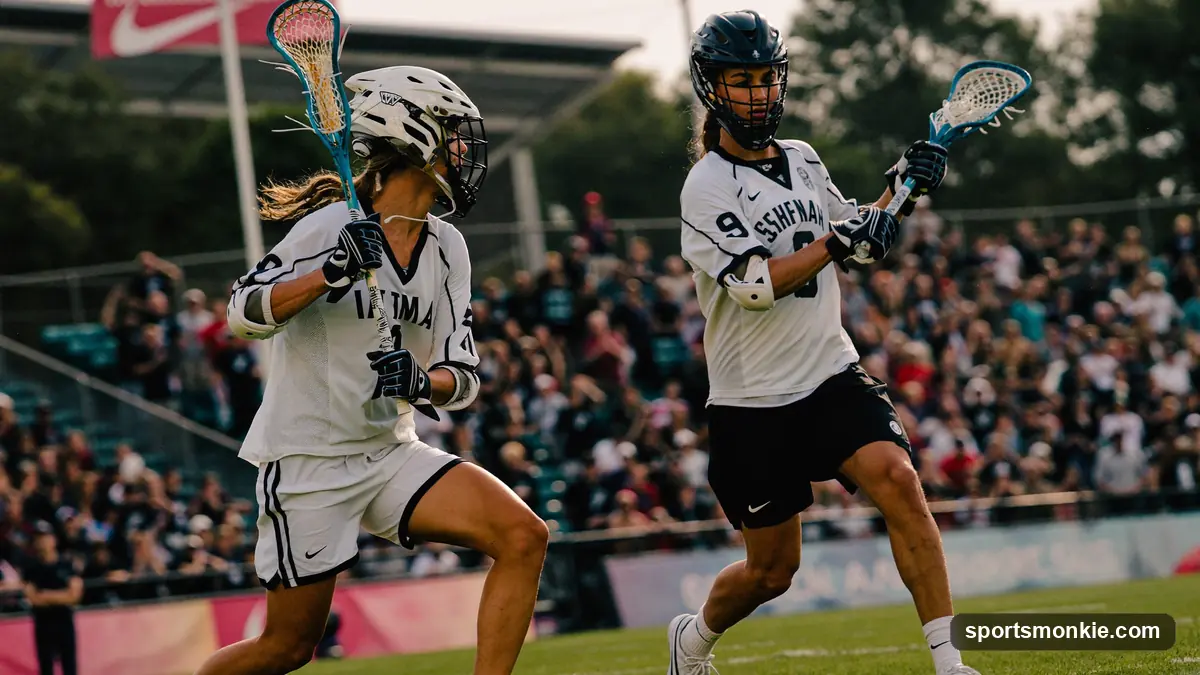 Two college lacrosse teams competing in a Division I game in front of stadium crowd