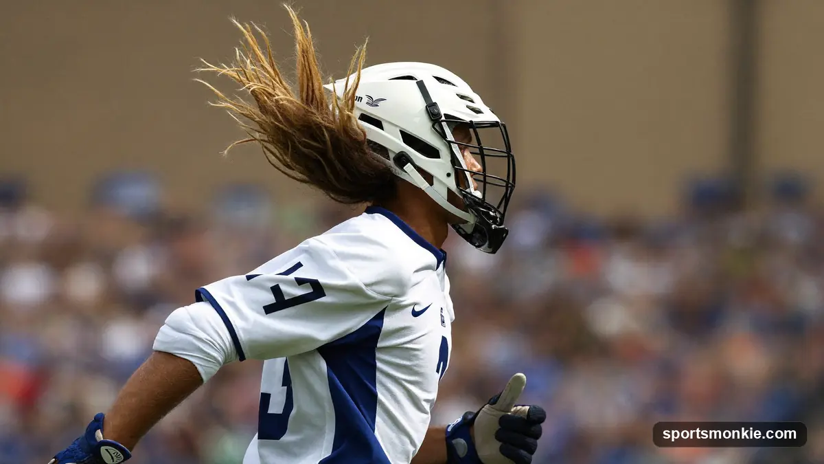 A lacrosse player mid-run with long hair streaming out from under the back of his helmet