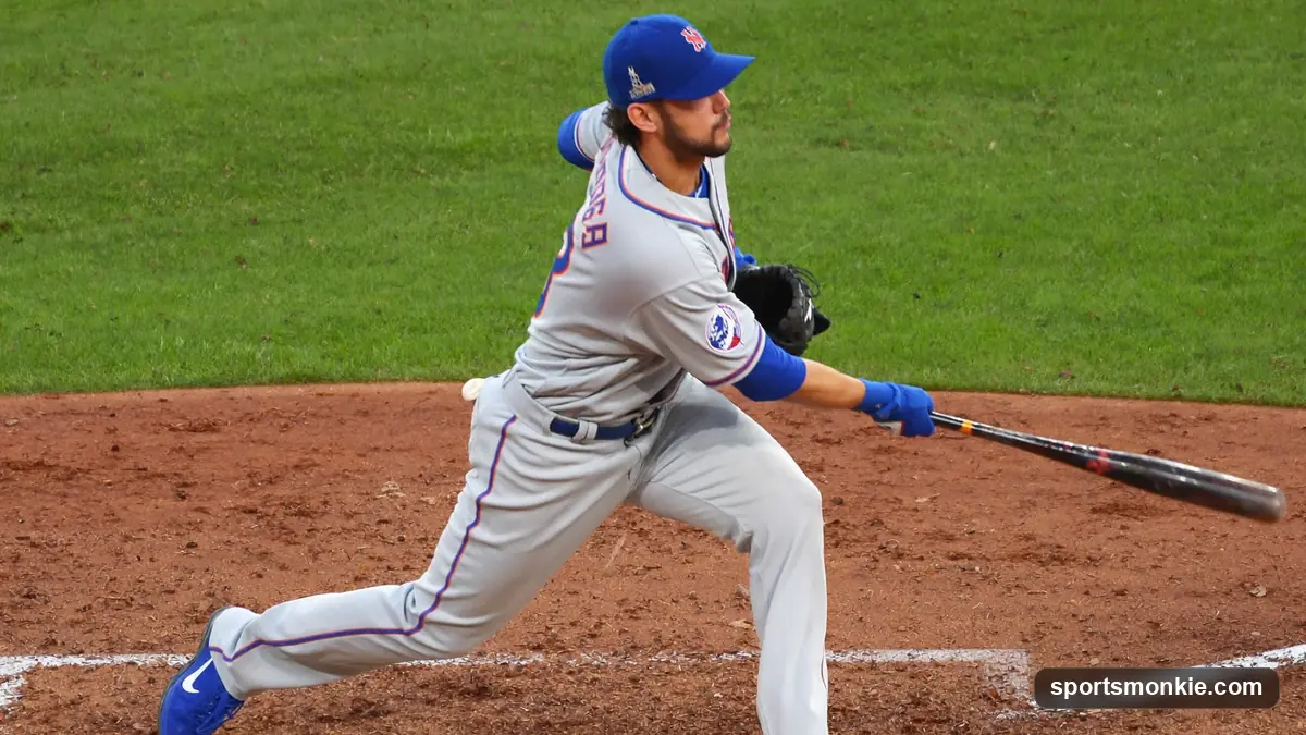 Baseball batter following through on a swing at a packed daytime ballpark