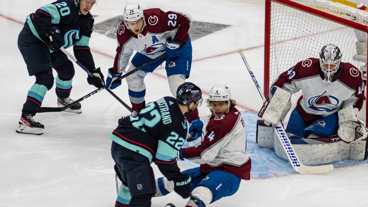 File photo from April 24, 2023: Nathan MacKinnon, centre, in a Colorado Avalanche uniform during a playoff game in Seattle. It does not show the Dallas game, and the cropped derivative is offered under the same CC BY-SA 2.0 licence as the original.