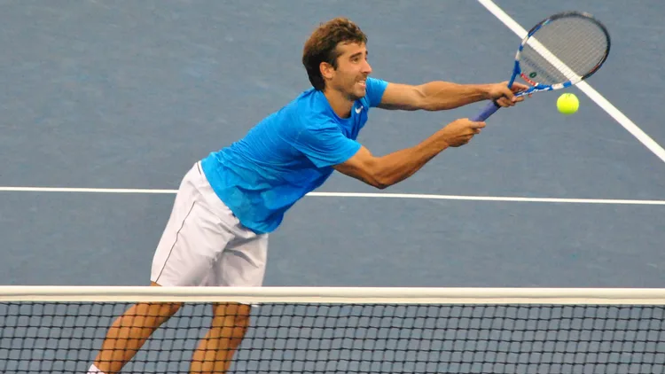 File photo from the 2012 US Open of Marc López playing a volley at the net. It does not show the Davis Cup. The 16:9 cropped derivative is offered under the same CC BY 2.0 licence.