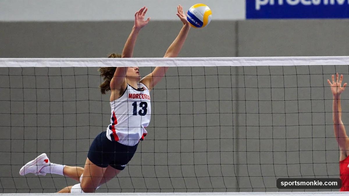 Middle blocker volleyball player jumping to attack a quick set at the net