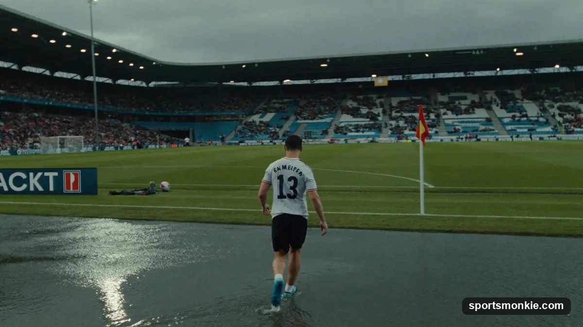 Footballer holding up a club shirt at a transfer unveiling in front of cameras