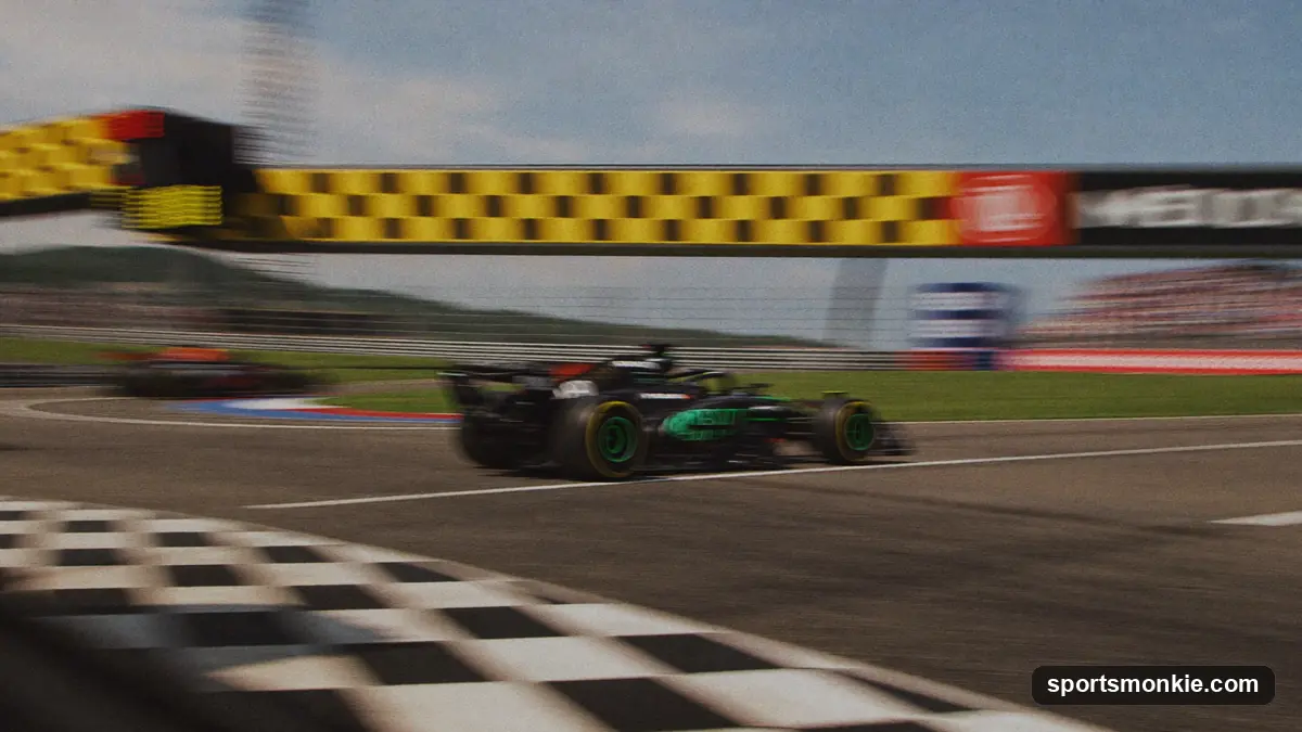 Formula 1 car crossing the finish line as a checkered flag waves above the track