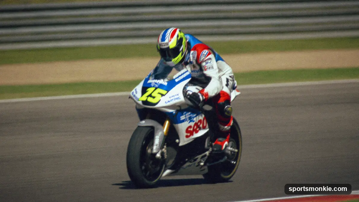 MotoGP rider leaning into a corner at high speed with knee to the tarmac