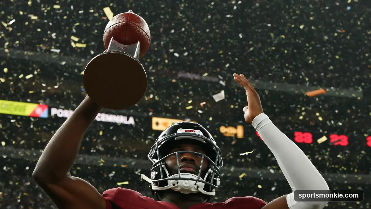 American football and championship trophy under stadium lights