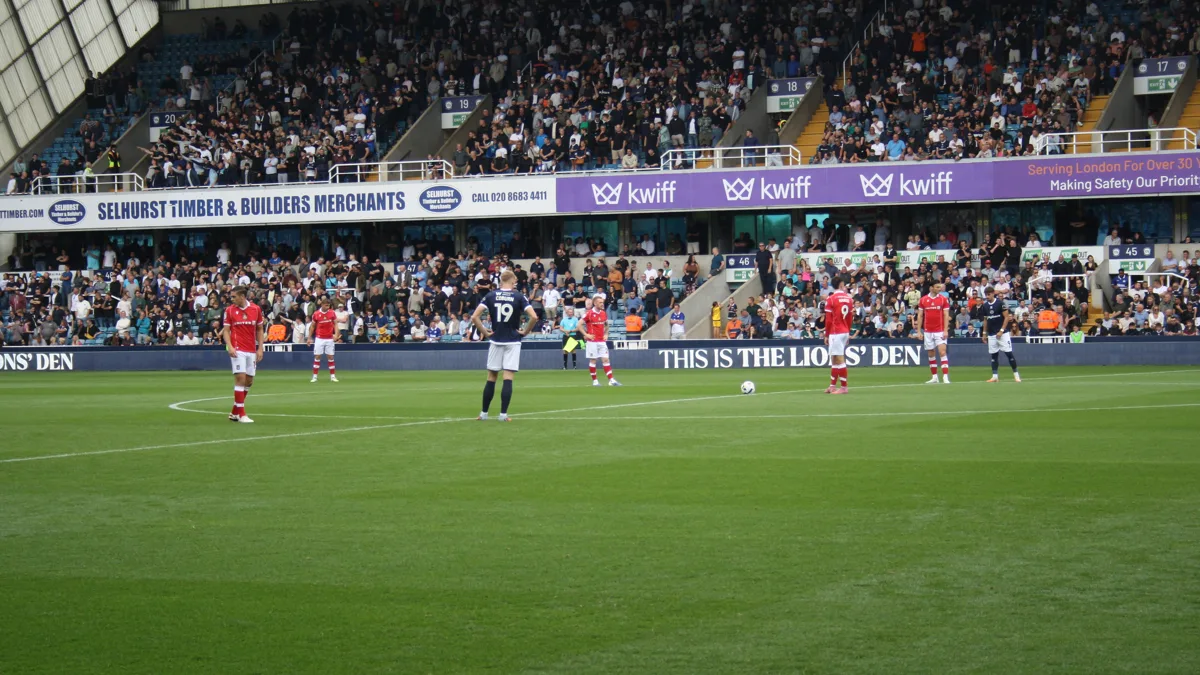 File photo from August 30, 2025: players on the pitch at The Den before Millwall played Wrexham. It does not show the Swansea match or the stoppage.