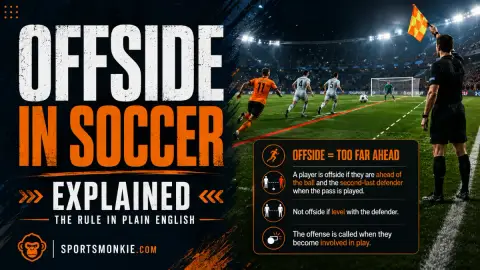 Soccer assistant referee raising the flag for offside with players on the pitch