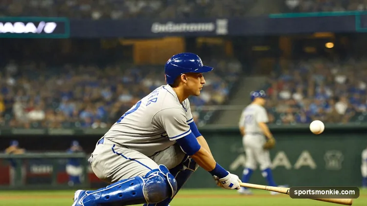A baseball batter squares around to bunt the ball toward the infield.