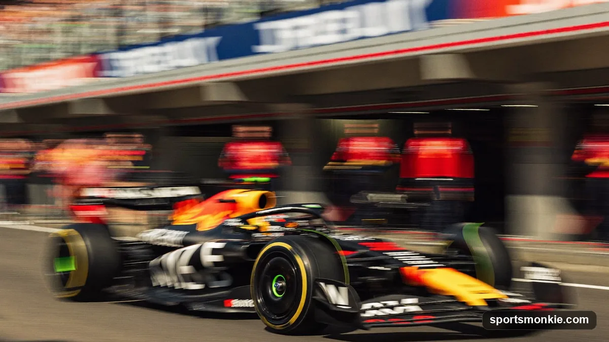 Formula 1 car driving down the pit lane past team garages during a race