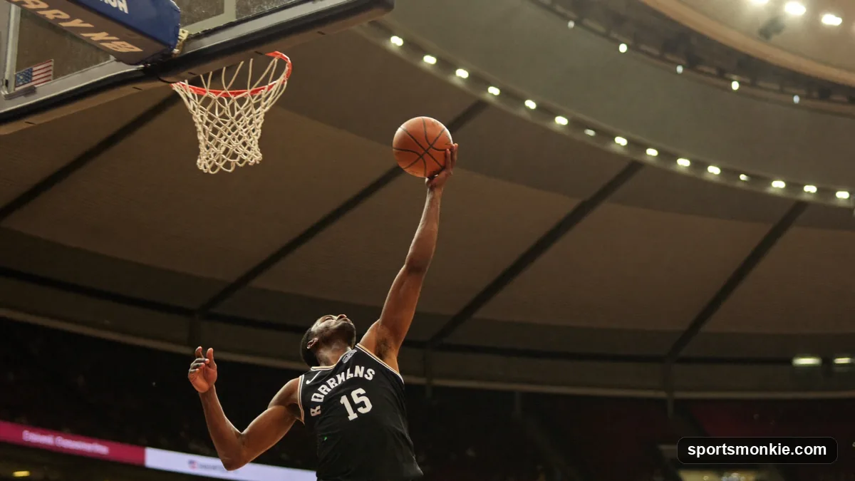 Basketball player driving to the hoop and laying the ball off the backboard for a layup