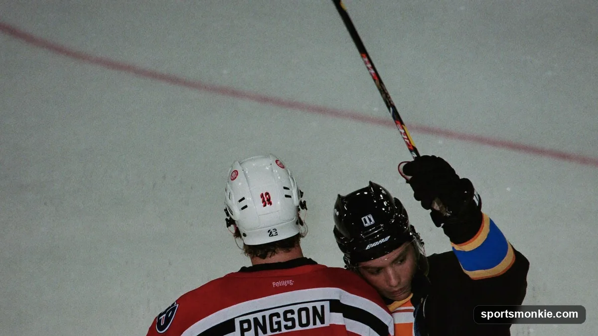 Referee raising an arm to signal a high-sticking penalty as a player's stick blade rises above shoulder height
