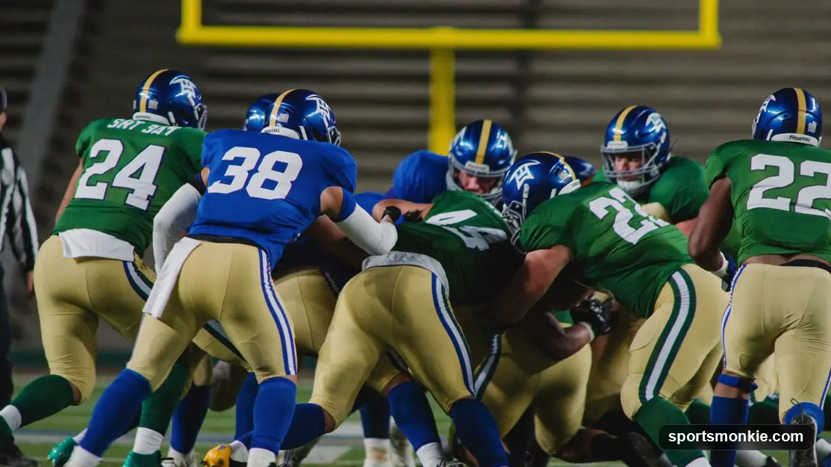 American football offensive and defensive linemen clashing at the line of scrimmage under stadium lights