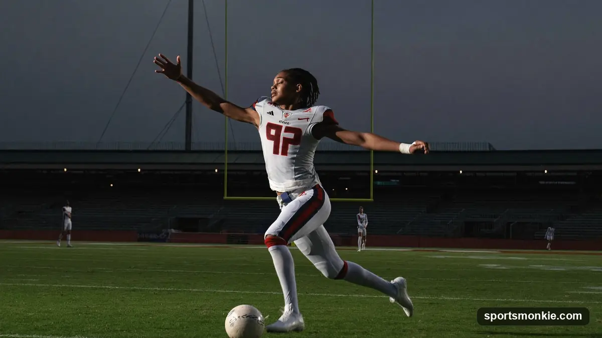 College football player running with the ball under stadium lights