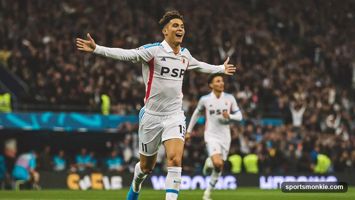 Teenage footballer celebrating a goal in front of a Premier League crowd
